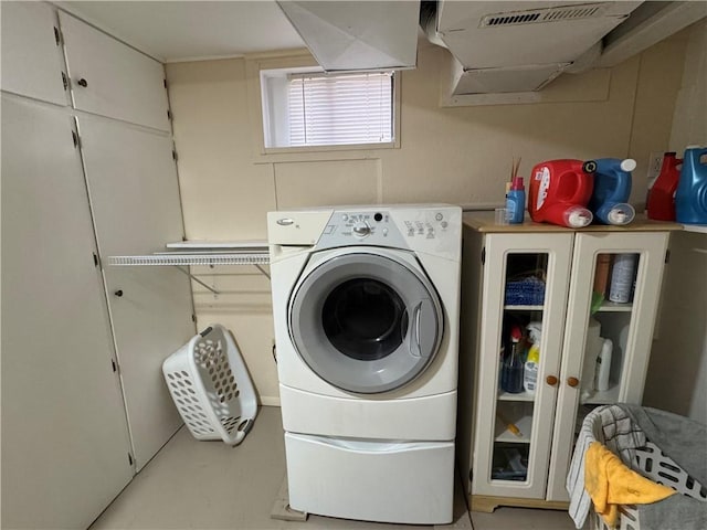 washroom featuring cabinet space and washer / dryer