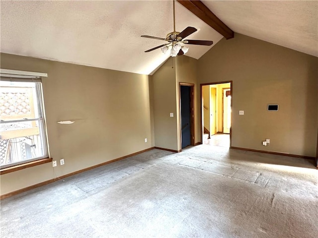 unfurnished room featuring baseboards, vaulted ceiling with beams, ceiling fan, a textured ceiling, and light carpet