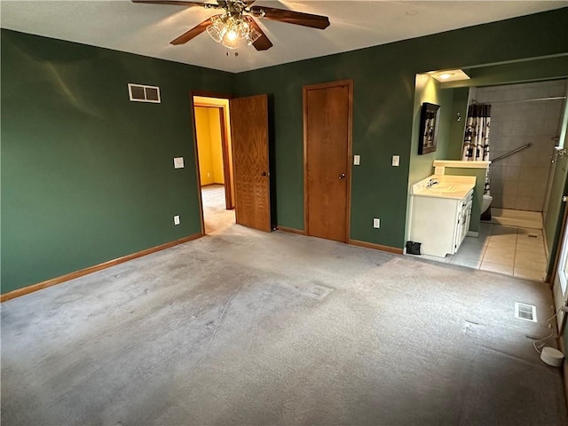 unfurnished bedroom featuring visible vents, connected bathroom, and baseboards