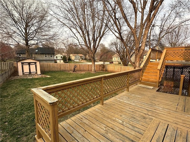 wooden terrace with a fenced backyard, a shed, a yard, and an outdoor structure