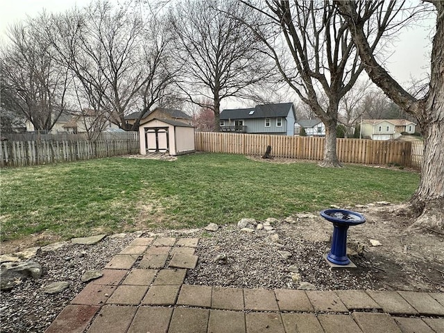 view of yard with an outbuilding, a shed, and a fenced backyard