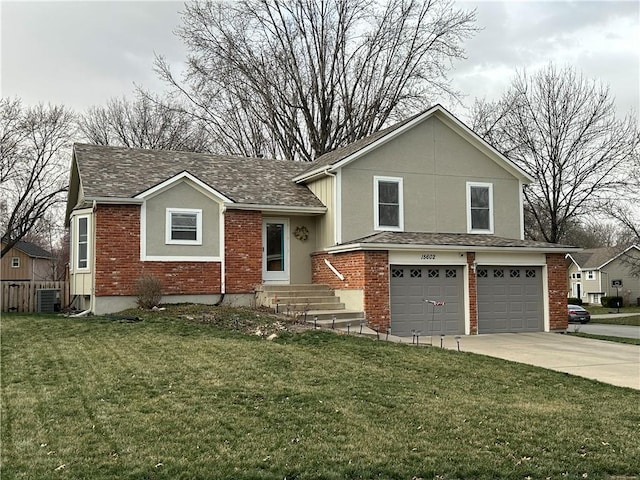 tri-level home featuring brick siding, central air condition unit, a front yard, driveway, and an attached garage