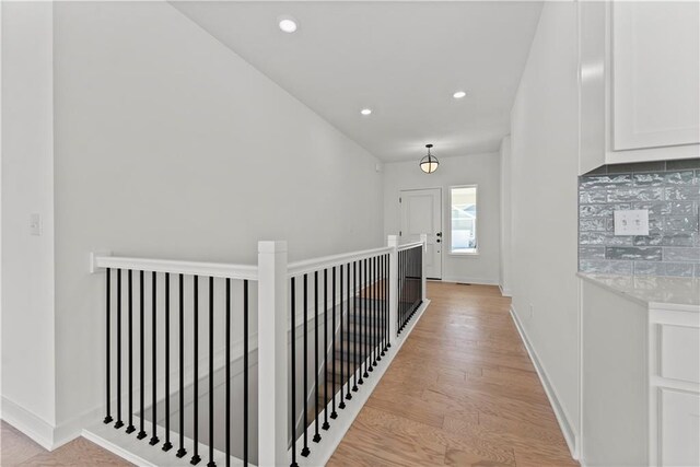 10612 N Jefferson St, Kansas City, MO 64155 - corridor with recessed lighting, light wood-type flooring, baseboards, and an upstairs landing