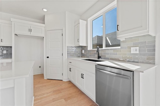 10612 N Jefferson St, Kansas City, MO 64155 - kitchen featuring a sink, dishwasher, light wood-style flooring, and white cabinets