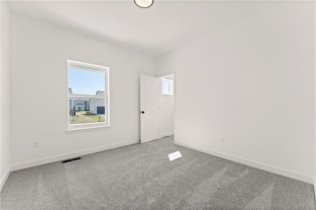 10612 N Jefferson St, Kansas City, MO 64155 - carpeted spare room with visible vents and baseboards