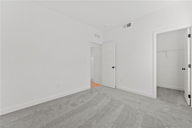 10612 N Jefferson St, Kansas City, MO 64155 - unfurnished bedroom with visible vents, carpet flooring, a walk in closet, and baseboards