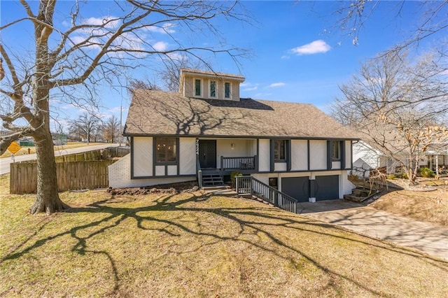 tudor home with fence, stairway, covered porch, a garage, and driveway