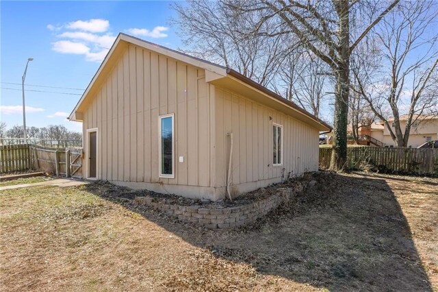 view of side of home featuring fence