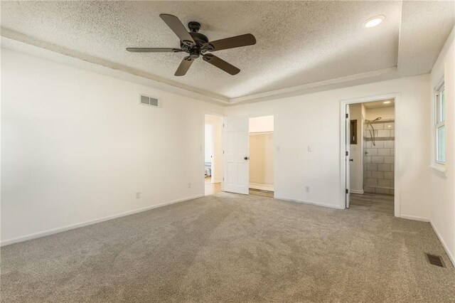 unfurnished bedroom with visible vents, a textured ceiling, baseboards, and carpet floors