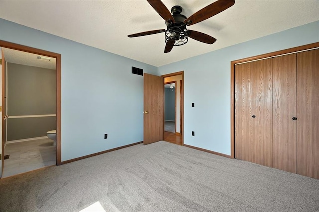 unfurnished bedroom with carpet flooring, baseboards, visible vents, and a closet