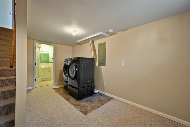 laundry room with baseboards, carpet floors, laundry area, electric panel, and independent washer and dryer