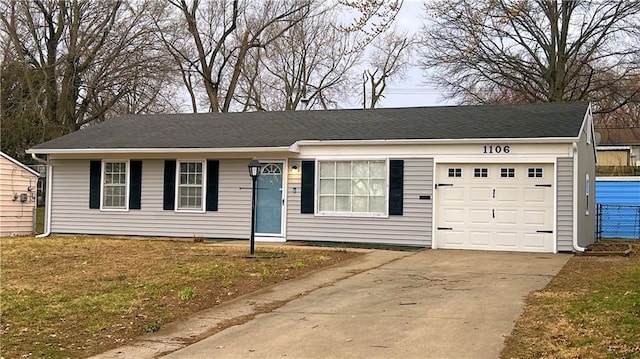 ranch-style house featuring a garage and driveway