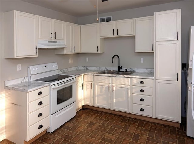 kitchen with under cabinet range hood, light countertops, white electric stove, white cabinetry, and a sink