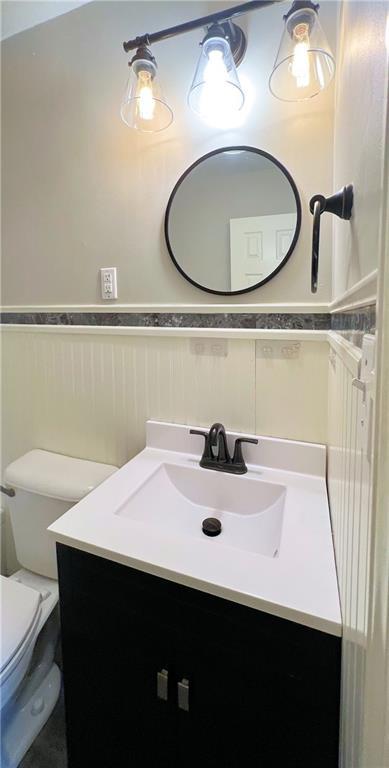 bathroom with toilet and vanity