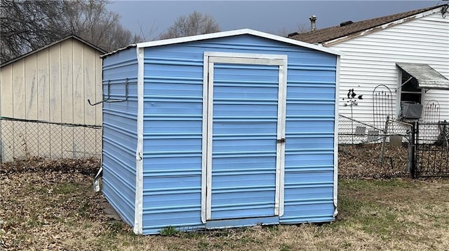 view of shed featuring fence