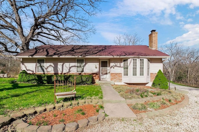 28314 S Bennett Rd, Freeman, MO 64746 - single story home featuring a front lawn, metal roof, brick siding, and a chimney