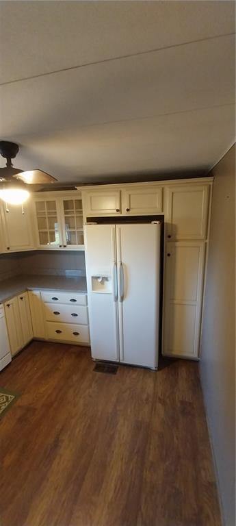 20824 NE 172nd St, Holt, MO 64048 - kitchen featuring a ceiling fan, dark wood finished floors, glass insert cabinets, white appliances, and cream cabinetry