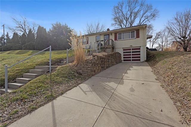 view of front of home featuring an attached garage, stairs, and driveway