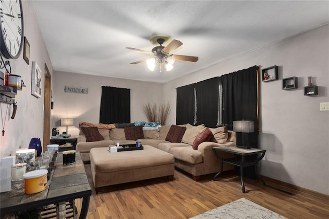 living room featuring ceiling fan and wood finished floors