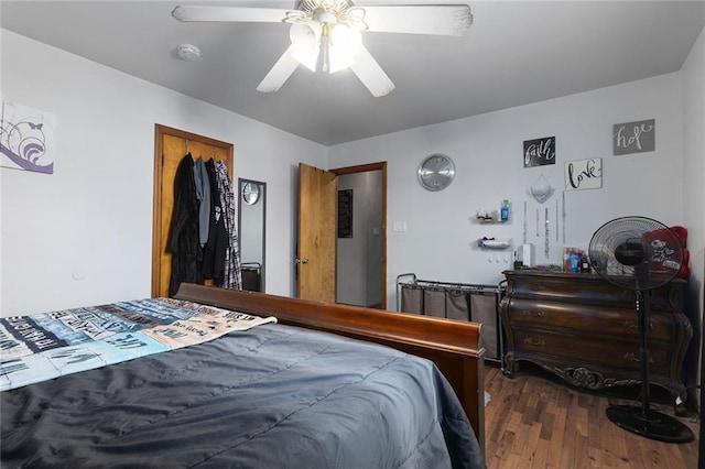 bedroom featuring a ceiling fan and dark wood-style flooring