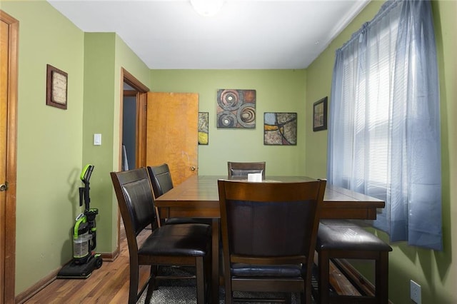 dining room with wood finished floors and baseboards