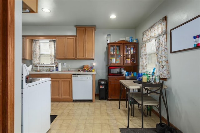 kitchen featuring dishwasher, range, black microwave, and a healthy amount of sunlight