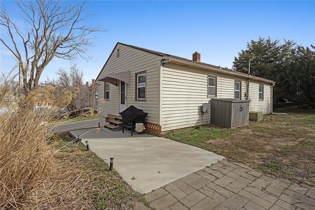 back of property with a chimney