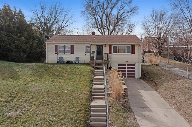 view of front of home with a front yard, stairway, driveway, an attached garage, and a chimney