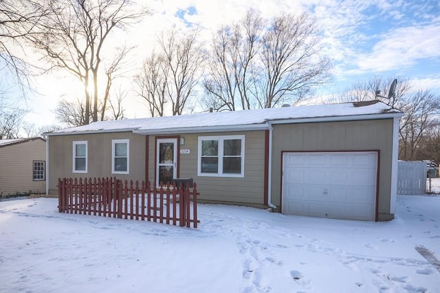 view of front of house with a garage and fence