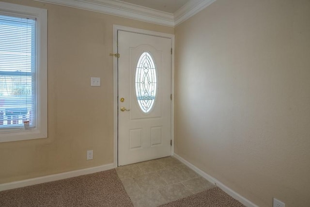 entrance foyer featuring light colored carpet, baseboards, and ornamental molding