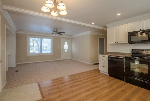 kitchen with light carpet, white cabinets, black appliances, and ornamental molding