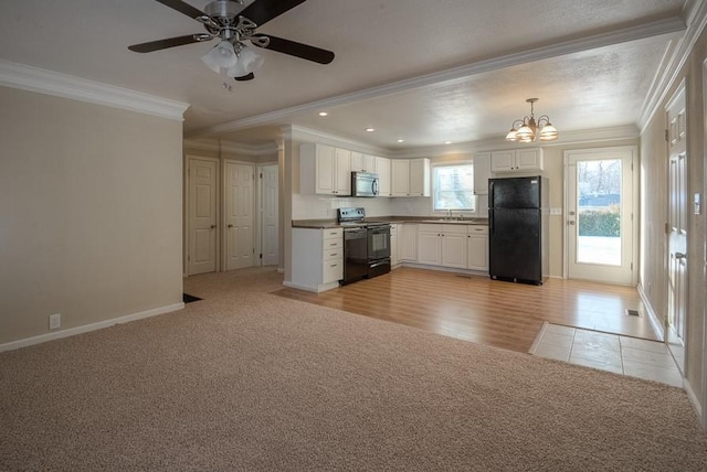 kitchen with light carpet, black appliances, a sink, white cabinetry, and crown molding