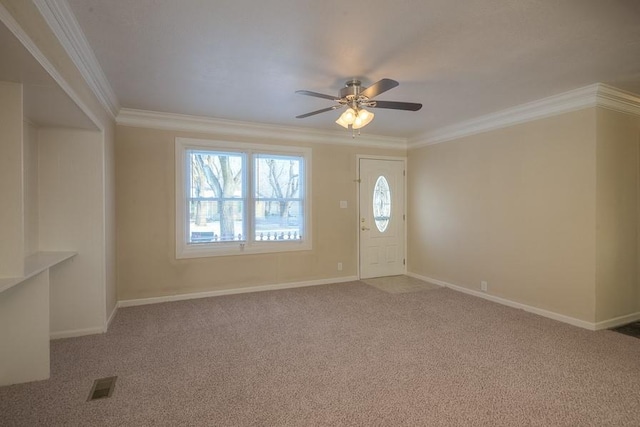 interior space featuring visible vents, ornamental molding, carpet flooring, baseboards, and ceiling fan