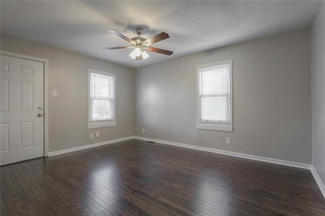 unfurnished room featuring baseboards, ceiling fan, and dark wood-style flooring