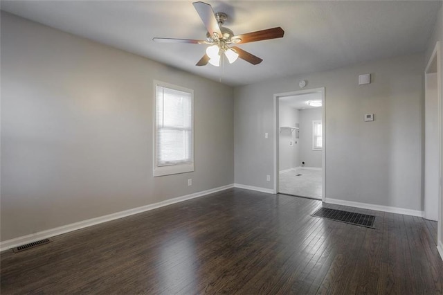 unfurnished bedroom with dark wood finished floors, baseboards, visible vents, and ceiling fan