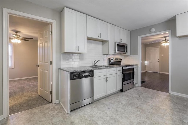 kitchen featuring ceiling fan, white cabinets, and stainless steel appliances