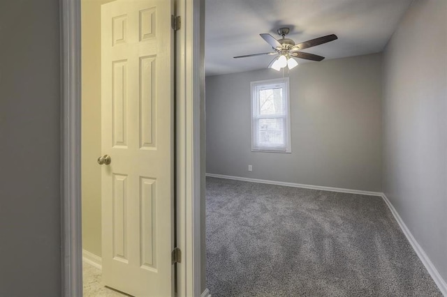 unfurnished room featuring light colored carpet, baseboards, and ceiling fan