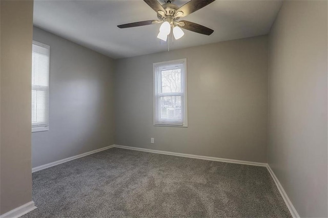 unfurnished room with baseboards, carpet, and a ceiling fan