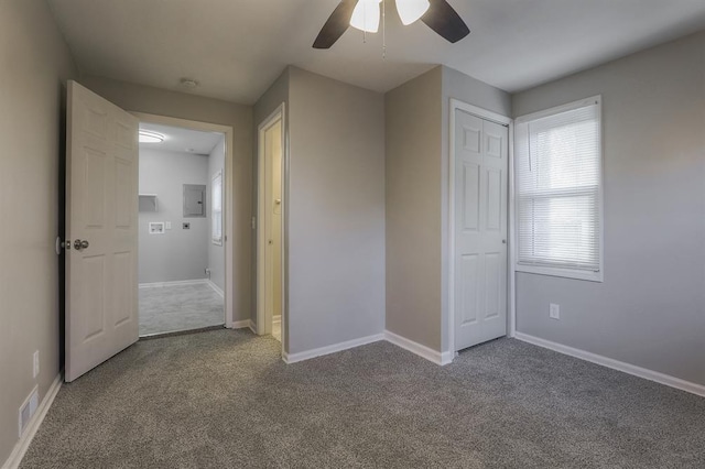 unfurnished bedroom with electric panel, baseboards, carpet floors, and visible vents