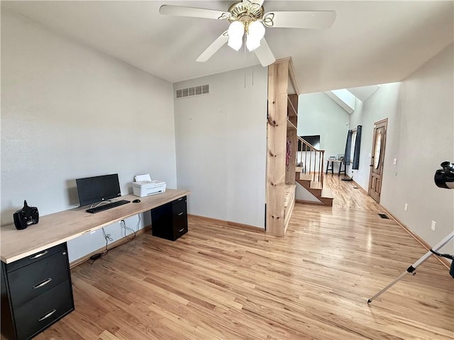 office space with light wood-type flooring, visible vents, a ceiling fan, and vaulted ceiling