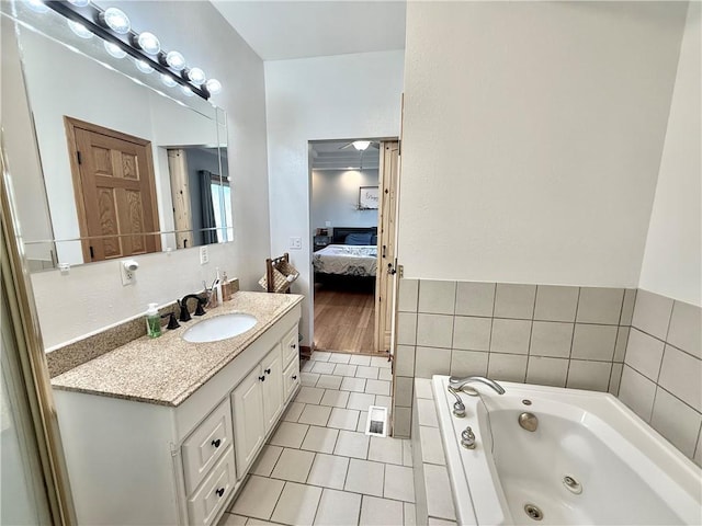 bathroom featuring visible vents, a jetted tub, ensuite bathroom, tile patterned floors, and vanity