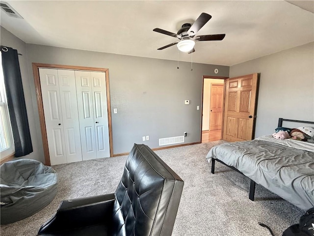 bedroom featuring a closet, visible vents, carpet flooring, and baseboards