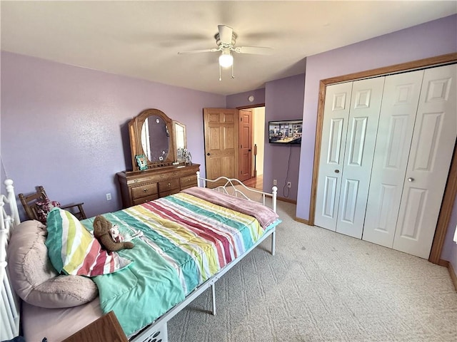 bedroom featuring a closet, light colored carpet, and ceiling fan