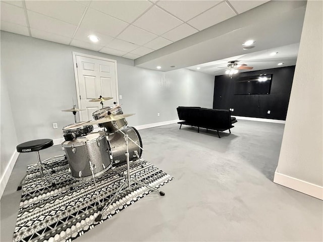 game room with recessed lighting, a paneled ceiling, baseboards, and concrete flooring