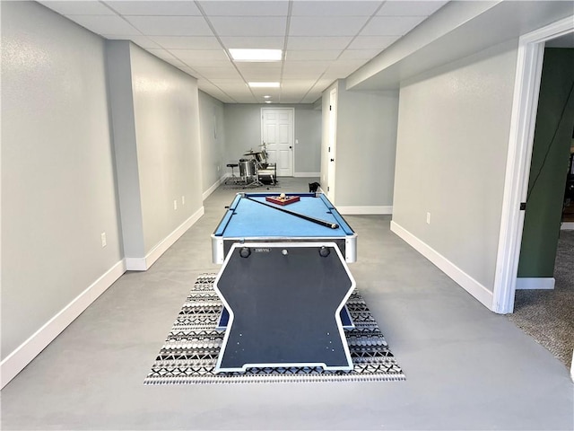 recreation room with billiards, a paneled ceiling, baseboards, and concrete flooring