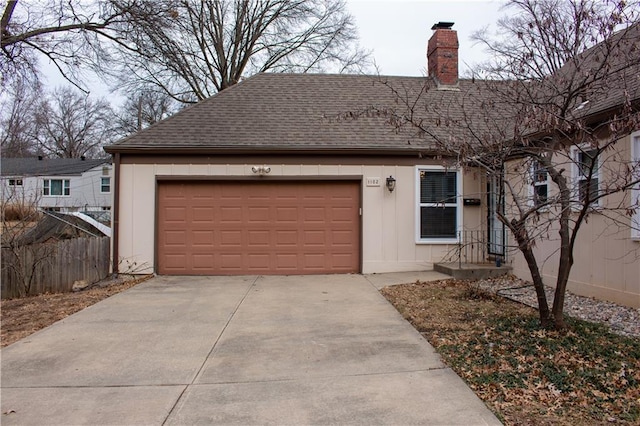 ranch-style house featuring an attached garage, fence, roof with shingles, and a chimney