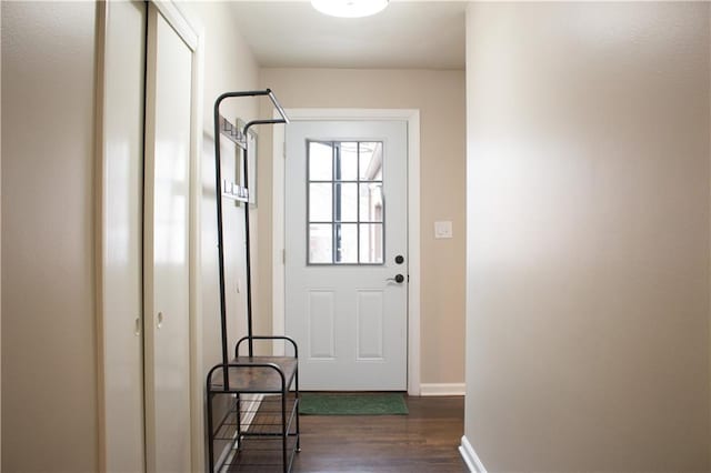 doorway to outside with baseboards and dark wood-style flooring