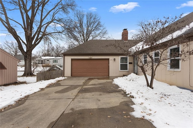 view of front of home with fence, roof with shingles, concrete driveway, an attached garage, and a chimney