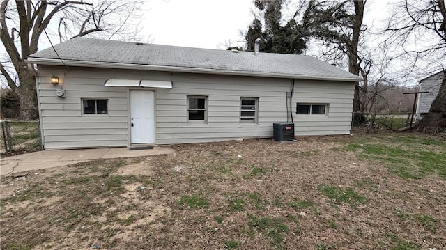 back of property with central AC and fence