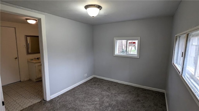 interior space with baseboards and carpet